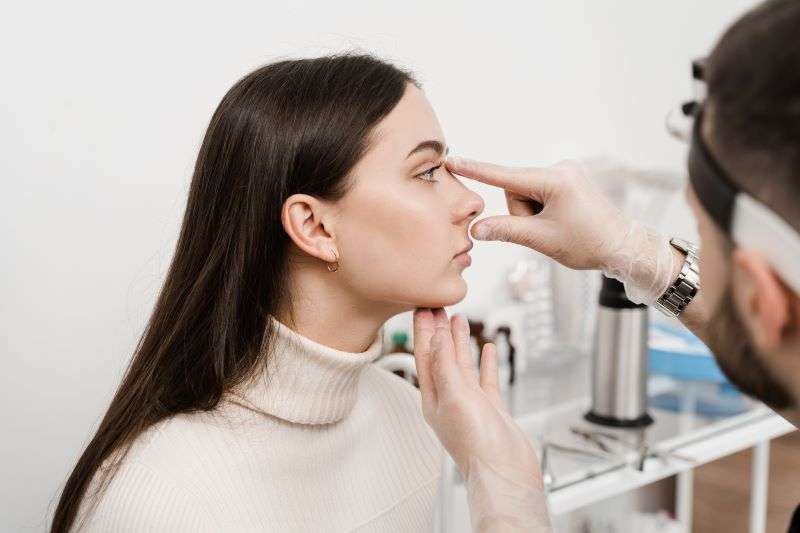 examining womans nose