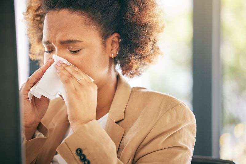 female blowing nose