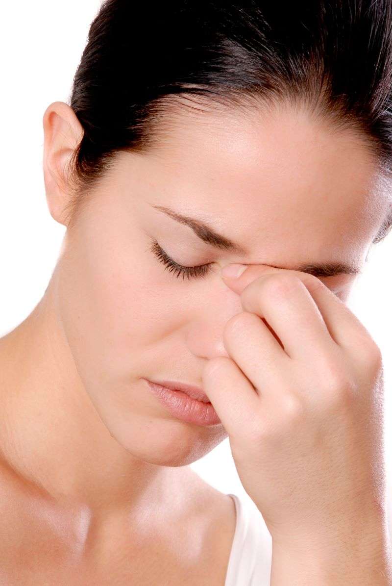 woman holding her nose